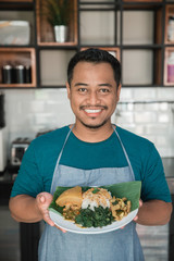 man carrying nasi padang