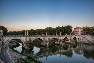 Pont St Angelo reflected in the Tiber river in Rome, Italy