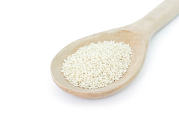 white sesame seeds in spoon on white backgroud