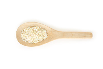 white sesame seeds in spoon on white backgroud