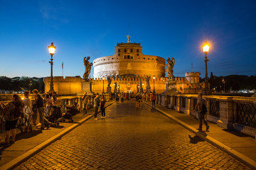 Tourists on the beautiful Pont Sant'Angelo bridge at night