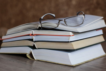 Stack of open books and glasses. Study. Literature. Writer. Read