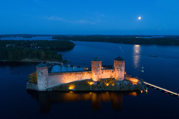 Olavinlinna fortress in the July night (aerial survey). Savonlinna, Finland