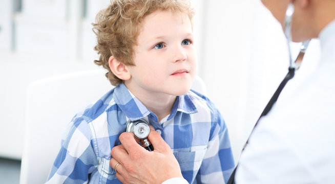 Doctor and child patient. Physician examines little boy by stethoscope. Medicine and children's therapy concept