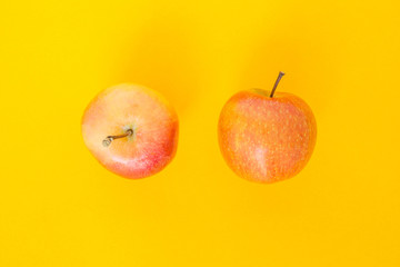 red apple top focus on yellow background