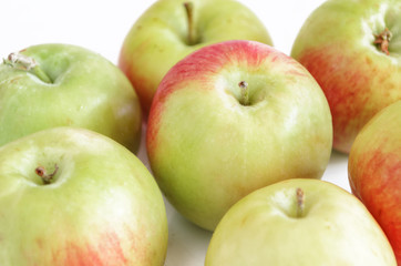 Green apples on a white background with a shadow.