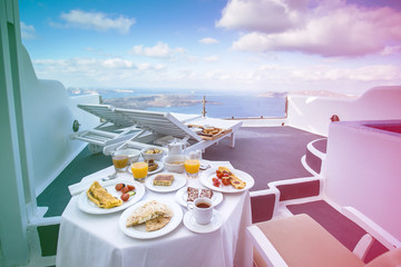 Gorgeous greek breakfast in idyllichotel varanda with sea and caldera view of Santorini, greece...