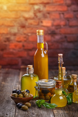 Olive oil in glass bottles and olives