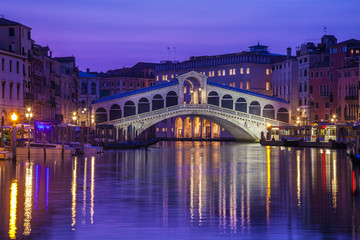 Venice's iconic Rialto Bridge illuminated at twilight