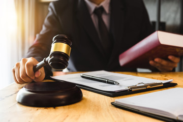justice and law concept.Male judge in a courtroom  the gavel, working with digital tablet computer...