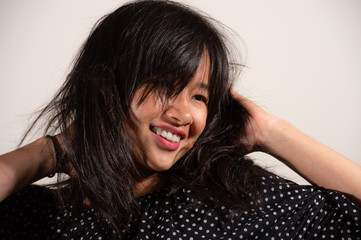Fototapeta premium Beauty portrait of asian woman in a black and white polka dot shirt and blue jeans dot shirt