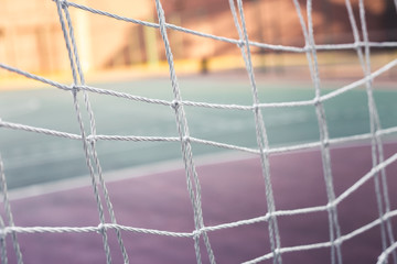 Close up front view photo from a goal net in a soccer court 