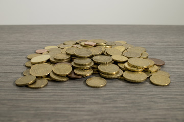 Lots of euro coins on a decorated wood table