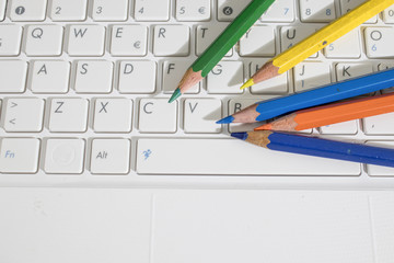 Colored pencils and a keyboard of a laptop