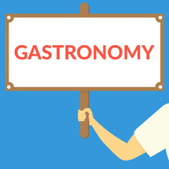 GASTRONOMY. Hand holding wooden sign