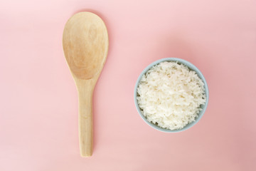 rice in bowl and spoon on pink background rose quartz