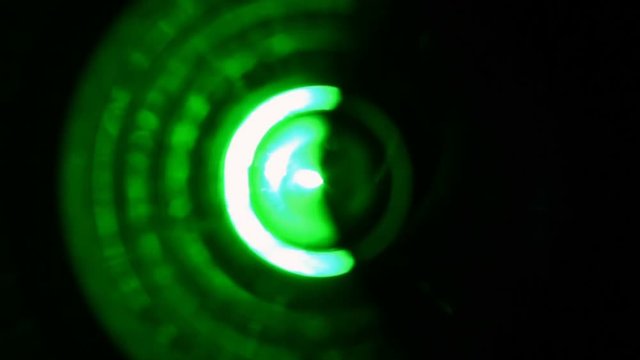 Extreme close-up of soft focused spinning green LED lights