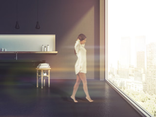 Fototapeta premium Gray panoramic bathroom interior, black tub, woman