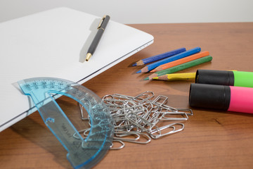 Stationery products, markers, clasps, pencils and a laptop