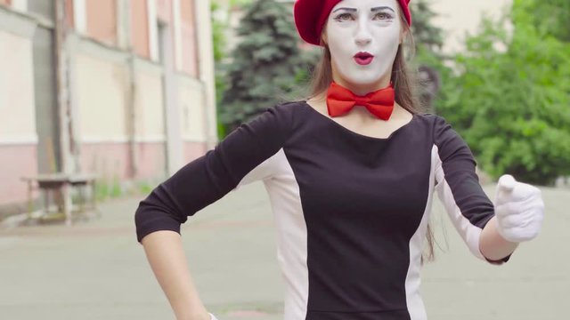 Mime girl imitates driving car
