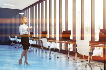 Woman in blue loft open space office interior