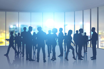 Business people silhouettes in night office