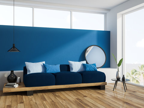 Blue sofa navy cushions in blue living room corner