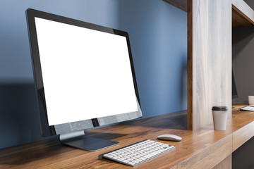Blank computer screen on a wooden table