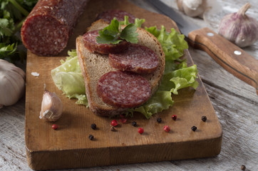 salami and bread on a wooden board