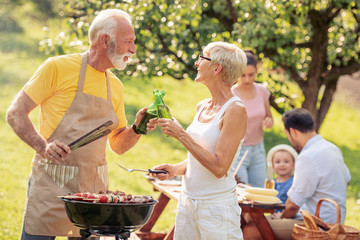 Family grilling meat on a barbecue