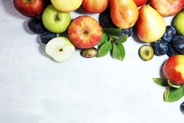 Various fresh fruits. Thanksgiving apples, and pears on rustic background.