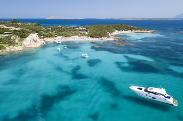 View from above, aerial picture of a yacht floating on the transparent and turquoise Mediterranean...