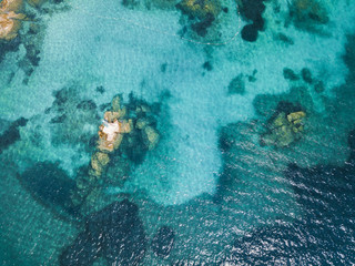 View from above, aerial picture of a turquoise and transparent Mediterranean sea. Emerald Coast, Sardinia, Italy.