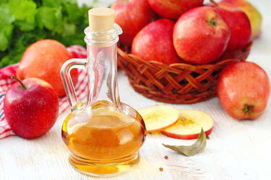 Apple vinegar. Bottle of apple vinegar on wooden background
