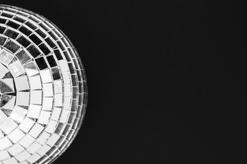 Dusty disco ball made from glass isolated on black background surface