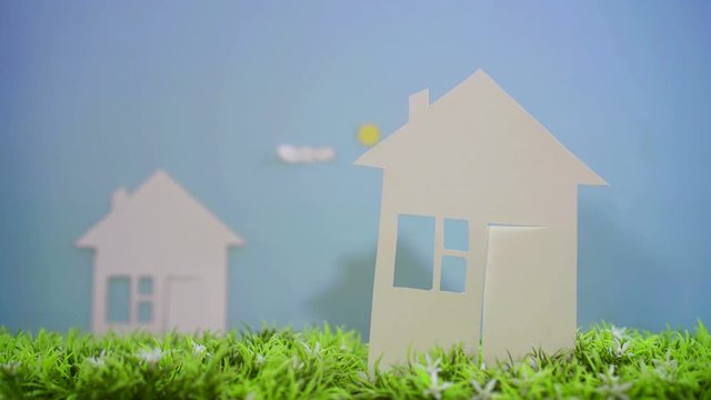 paper house on green grass, concept idea