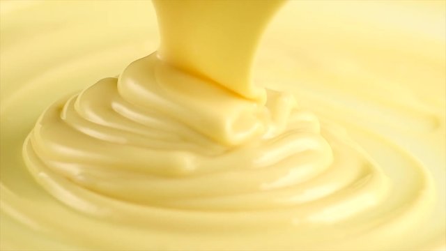 White chocolate. Pouring melted liquid premium white chocolate. Confectionery. Slow motion. 3840X2160 4K UHD video footage