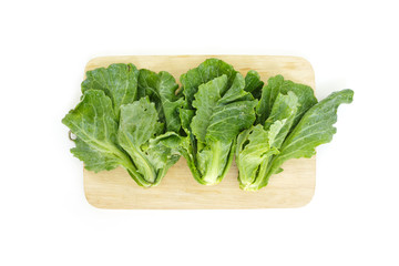 chinese kale on cutting board top view on white background