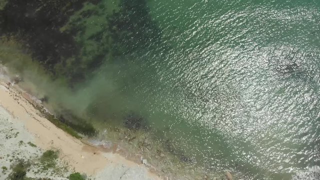 Aerial view of stony seashore and waves