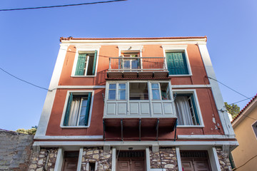 Bottom shot of perspective multi storey building orange colored facade at Lesvos in central part of region