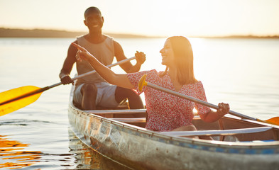Young woman enjoying the scenery while canoeing with her boyfrie