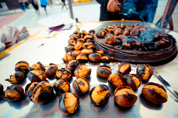 Fried chestnuts on the street. Street food. Roasted chestnuts