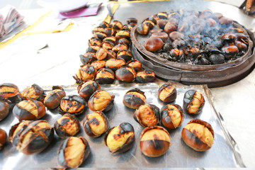 Fototapeta na wymiar Fried chestnuts on the street. Street food. Roasted chestnuts