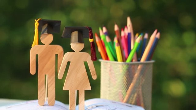 Back to School Concept, Two People Sign wood with Graduation celebrating cap on open textbook show alternative studying. Graduate or Education knowledge learning study abroad international Ideas.