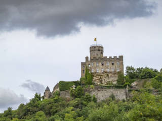 Fototapeta na wymiar Dramatic picture of the rock Castle of Pyrmont in Germany against a moody September sky as seen from the main road below