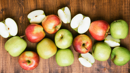 Naklejka na ściany i meble Sweet juicy red and green apples on wooden background. Free copy space for text. Top view, flat lay