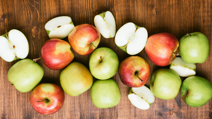 Sweet juicy red and green apples on wooden background. Free copy space for text. Top view, flat lay