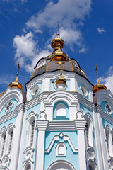 Fototapeta na wymiar Orthodox temple of saint Alexander in city Kharkiv (Ukraine). Temple in a bright sunny summer day on a blue sky background.
