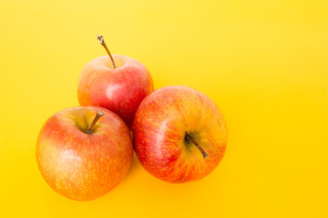 red apple on yellow background