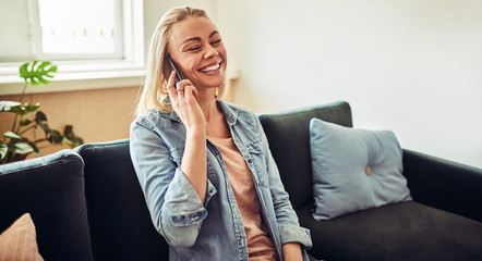 Smiling young businesswoman talking on a cellphone in an office